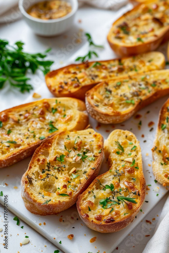 Garlic bread sprinkled with herbs  presented on a white backdrop