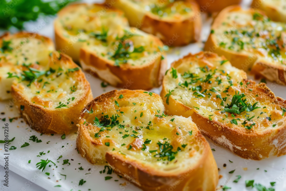 Garlic bread sprinkled with herbs, presented on a white backdrop Garlic bread sprinkled with herbs, presented on a white backdrop