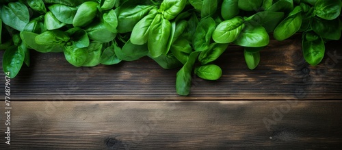 Fresh spinach leaves arranged in a bundle are displayed in close-up detail on a rustic wooden table