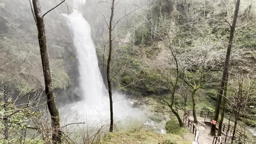 Stunning waterfall in the forest in spring season photo