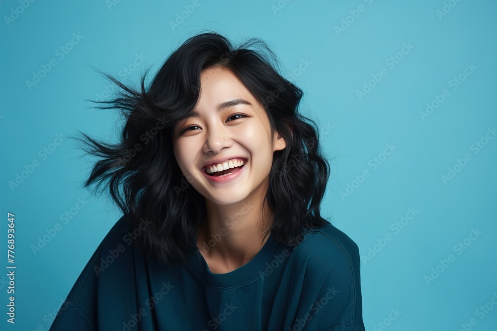 A woman with long hair is smiling and laughing A woman with long hair is smiling and laughing