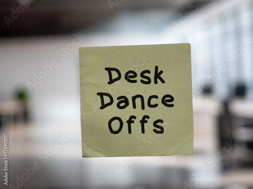 Post note on glass with 'Desk Dance Offs'.