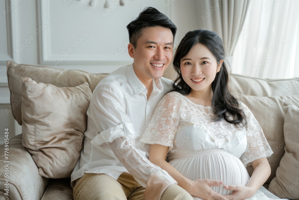 happy asia Pregnant woman and husband sitting on sofa newborn mother's day and baby shower happy asia Pregnant woman and husband sitting on sofa newborn mother's day and baby shower