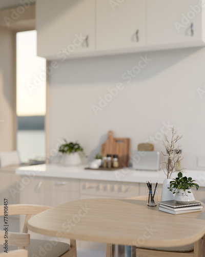 An empty space for display products on a wooden dining table in a contemporary, minimalist kitchen. © bongkarn