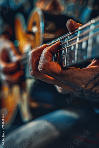A man is playing a guitar with his fingers