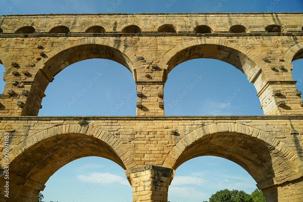 Pont du Gard famous aqueduct arched bridge close-up view, popular tourist landmark in France