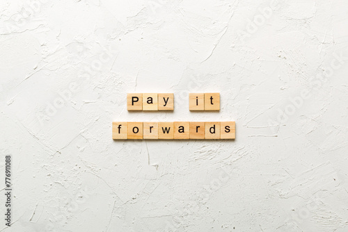 Pay It Forward word written on wood block. Pay It Forward text on cement table for your desing, concept