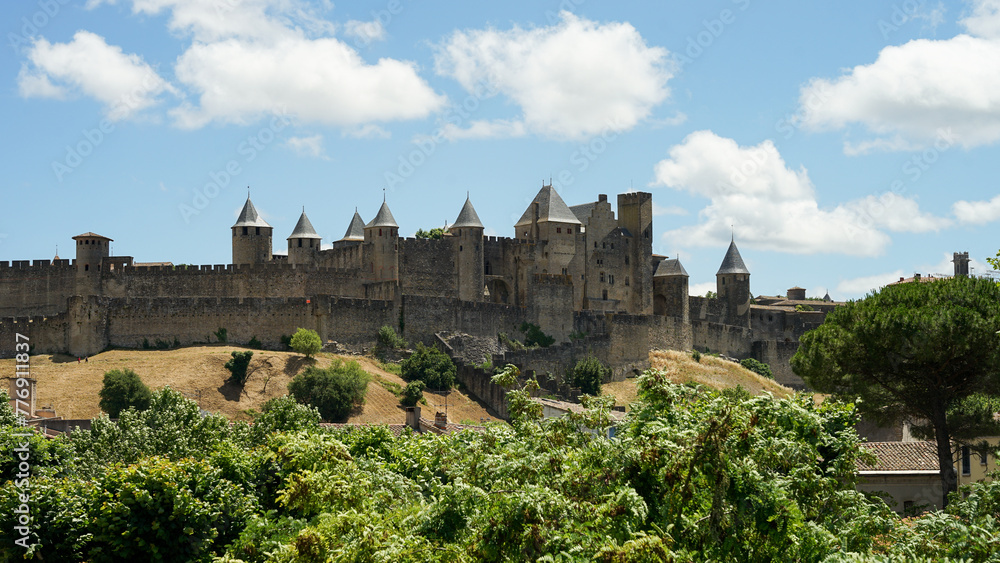 Carcassonne hillltop medieval citadel castle with watchtowers and fortification panoramic view, popular tourist destination, France