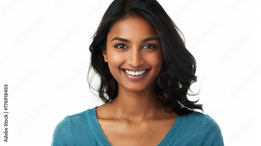 A beautiful Indian woman with dark hair wearing a blue top smiling against a white background in a studio shot A beautiful Indian woman with dark hair wearing a blue top smiling against a white background in a studio shot