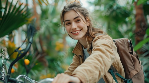 A Happy young woman riding bicycle in the green plants Cityscape and going to work photo