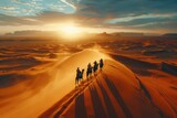 Aerial view of Arabs riding camels walking across the vast desert