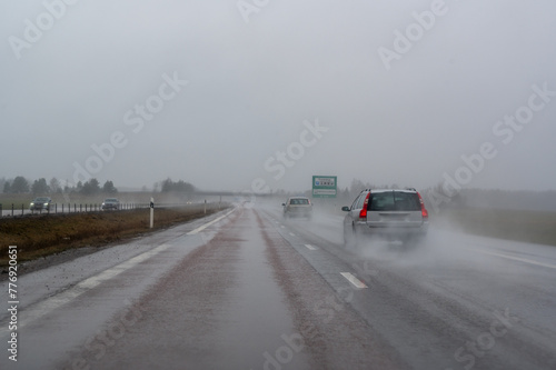 Gray misty weather with water on the road outside Orebro Sweden