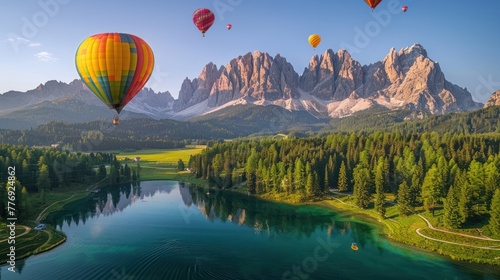 Hot air balloons flying over the Lago di Carezza in Dolomites photo