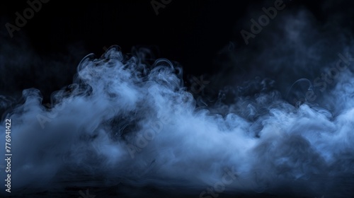 Mystical blue smoke. Wisps of smoke rising from the ground on a dark background, suitable for spooky or atmospheric themes.