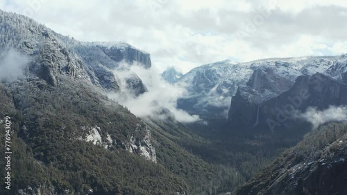 Aerial moving shot of Yosemite, Half Dome, El Capitan in winter snow photo
