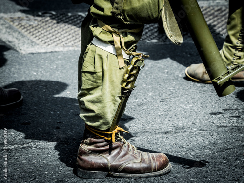 Second world war commemoration at SAINTE MERE L'EGLISE In Normandy, FRANCE. Close-up vintage shoes soldier and rifle second war army