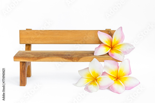 Wooden bench with plumeria flower on white background, wooden furniture