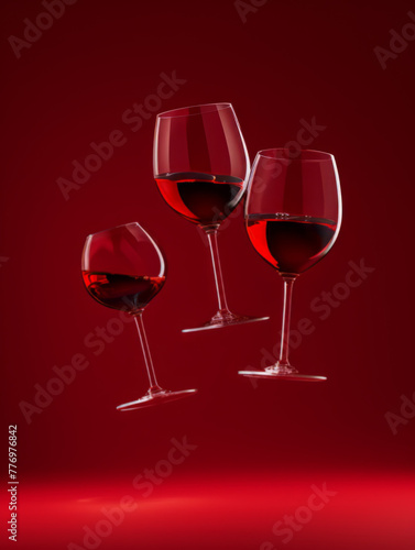 Elegant Float of Red Wine Glasses in Mid-Air with Red Monochromatic Backdrop