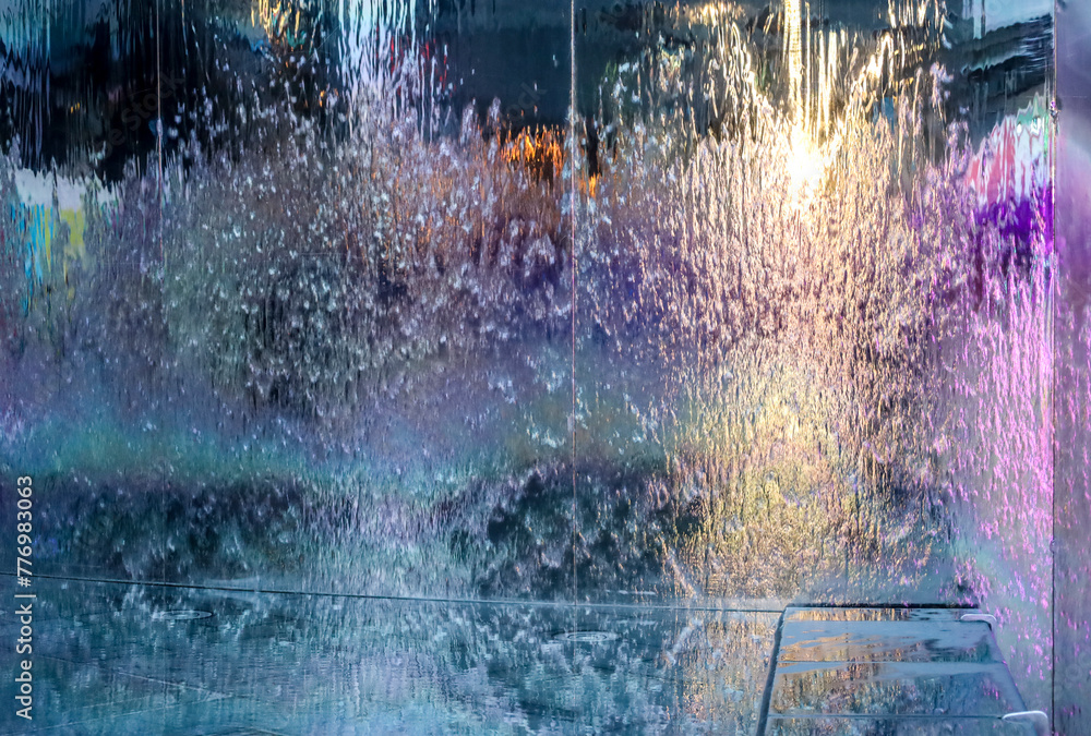 Fototapeta premium Running water on metal surface with multicolor reflections