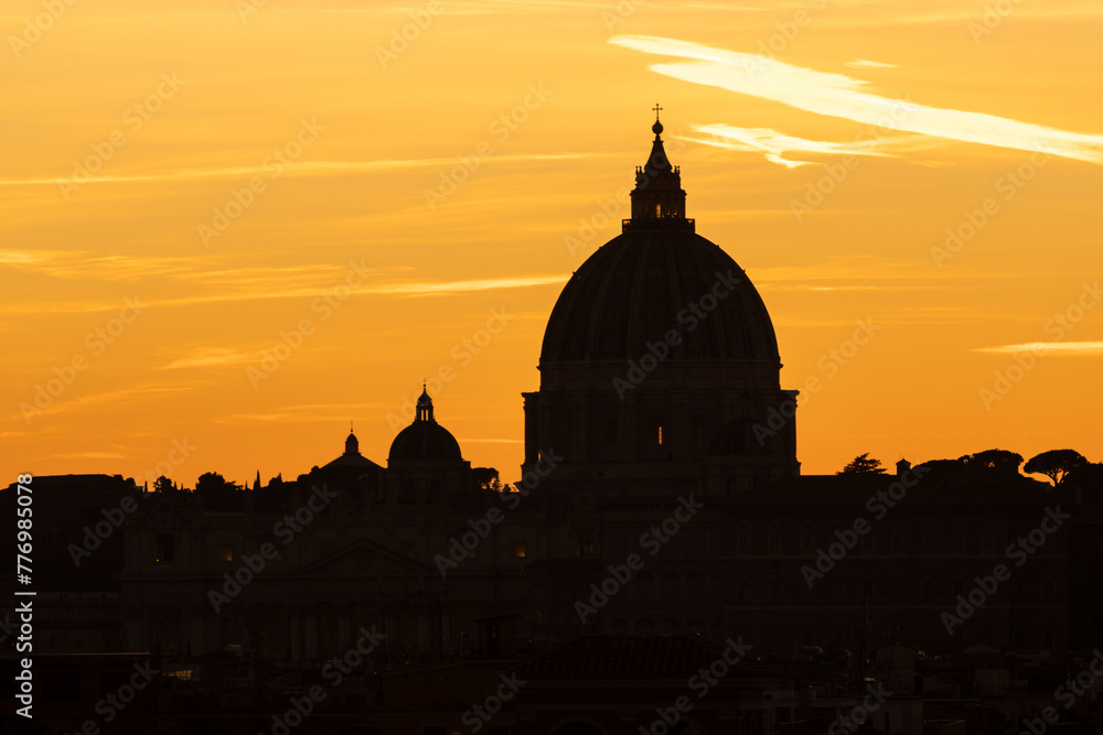 Famous St. Peter dome at sunset. Vatican state. Rome, Italy