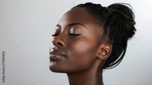 Young African woman shows off smooth facial skin. Facial skin care concept.