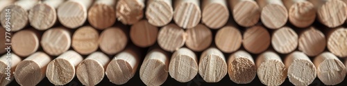 Collection of uniform, cylindrical wooden pencils on a wooden background close-up, banner photo