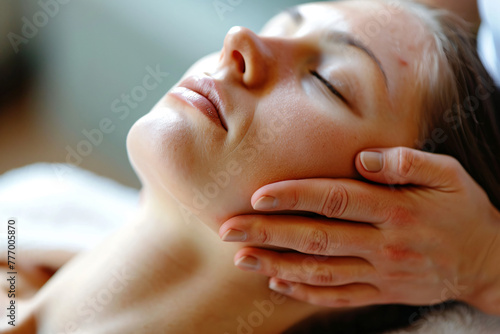 woman receiving a facial massage in a spa salon, closeup of her face and hands