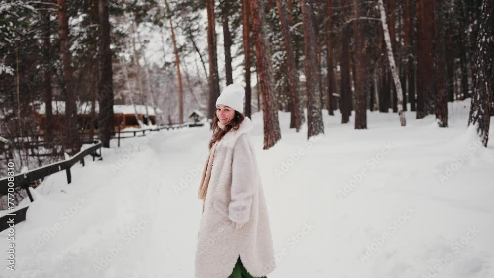 Happy woman smiling and walking outdoors, having fun during winter holidays. Pleasure and travel concept. Snowy forest Happy woman smiling and walking outdoors, having fun during winter holidays. Pleasure and travel concept. Snowy forest