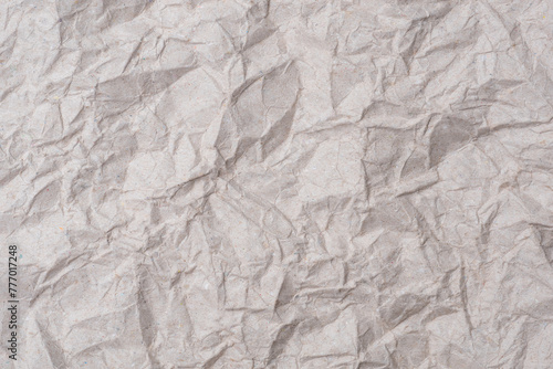 Gray crumpled KI kraft paper texture background. The old wrinkled craft paper backdrop for recycling