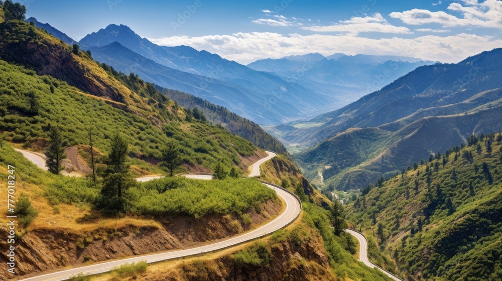 A winding road in the mountains with a scenic view of the landscape