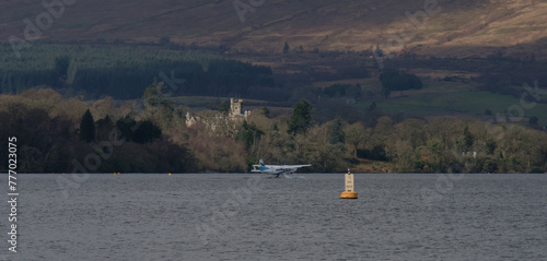 Float plane (sea plane) taxiing ready for take off on a large lake (loch)