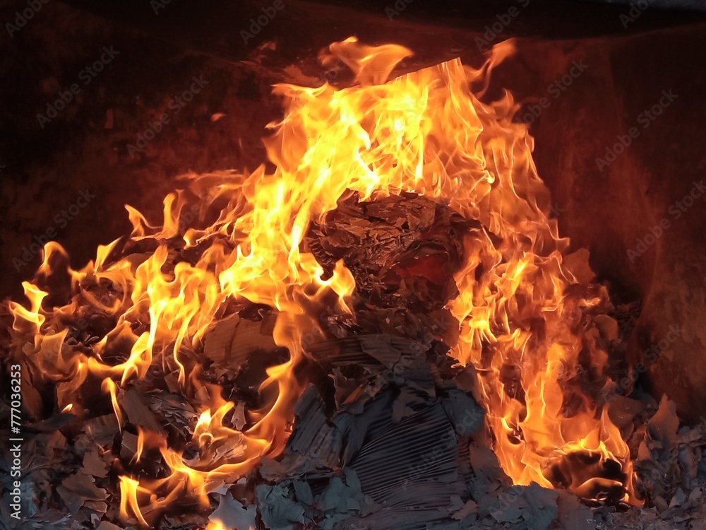 Burning firepaper and coals of a fire. Background for grilled food with fire. Burning firepaper and coals of a fire. Background for grilled food with fire.