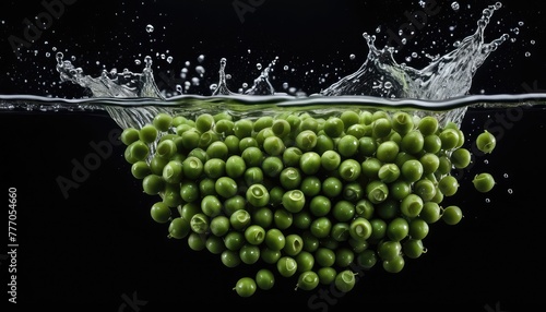 Fresh green peas plunging into water  creating captivating splashes against a sleek black backdrop  a vibrant burst of color.