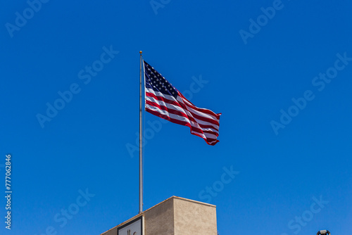 American Flag waving at the top of the Grove Parking Lot, located in Farmers Market Place between West Third Street and Beverly Boulevard.
