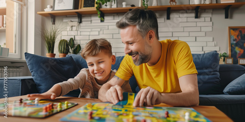 Young father and his ten years old son playing board game at home. Dad and his kid having fun with table game in a living room. Bonding and spending quality time with children. photo