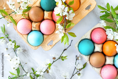 colourful Easter eggs in a package decorated with flowering tree branches. spring holidays, preparation for the Easter holiday, spring mood, Christian Easter, Easter postcard © Маргарита Трушина