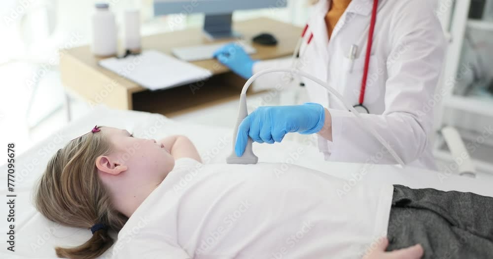 Doctor cardiologist making ultrasound examination of heart to child in clinic 4k movie slow motion. Diagnostics and treatment of pathology of cardiovascular system in children concept Doctor cardiologist making ultrasound examination of heart to child in clinic 4k movie slow motion. Diagnostics and treatment of pathology of cardiovascular system in children concept