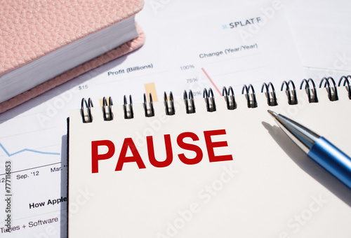 The word PAUSE on a paper notepad. Business break concept