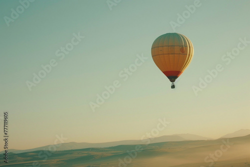 An HD photograph of a colorful hot air balloon floating in a clear sky, evoking a sense of adventure and freedom. © CREATER CENTER