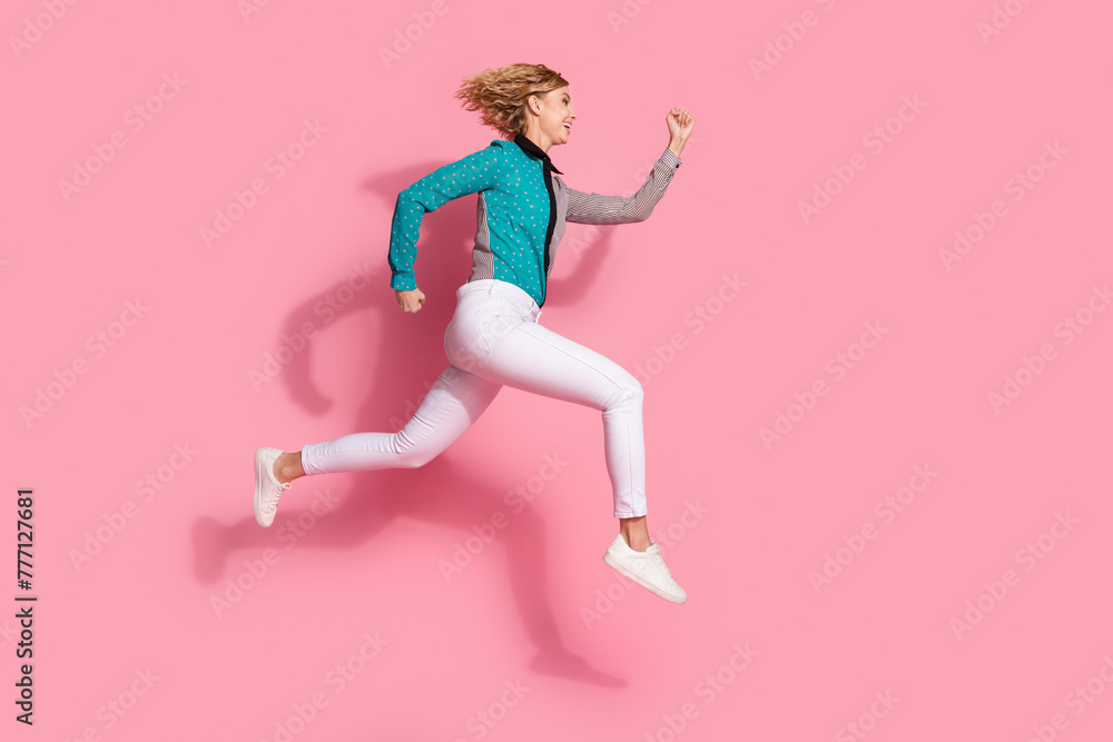 Full size photo of pretty young girl running black friday shopping wear trendy striped cyan outfit isolated on pink color background