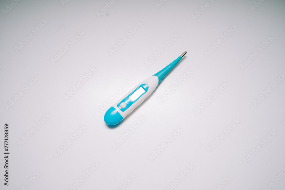 a body temperature measuring device for children placed on a white base a body temperature measuring device for children placed on a white base