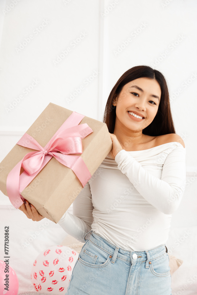 Portrait of cute beautiful smiling asian woman holding birthday present Portrait of cute beautiful smiling asian woman holding birthday present