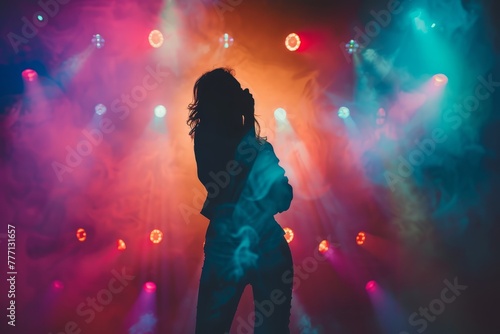 Silhouette of a Performer with Vibrant Stage Lights