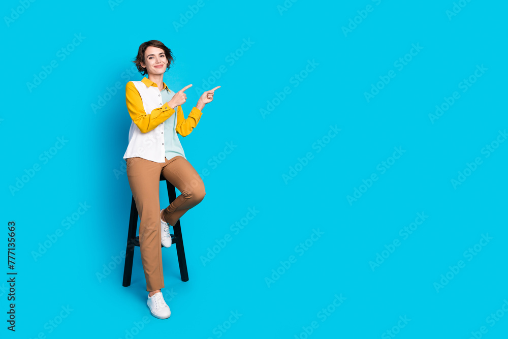 Fototapeta premium Photo of manager lady sitting chair demonstrate promo empty space isolated over blue color background