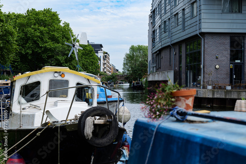 London - 06 03 2022: Views of houseboats on the Regent's Canal with the Whitmore Bridge in the background photo