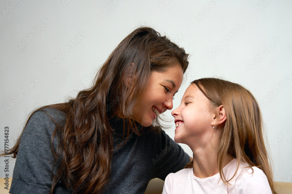 Happy mother having fun with her daughter, close-up portrait Happy mother having fun with her daughter, close-up portrait