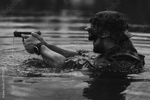 Cuadro en lienzo A special forces military man in the water with a pistol, black and white photo