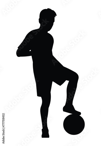 Silhouette of a boy standing in a half-turn placing his foot on the ball on junior football training or championship