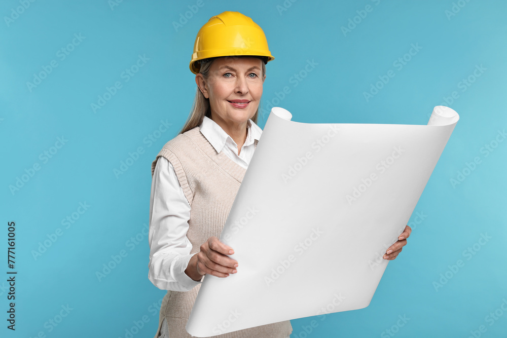 Architect in hard hat with draft on light blue background Architect in hard hat with draft on light blue background
