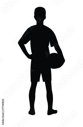 Black silhouette of a boy football player standing from the back holding a ball in his hand